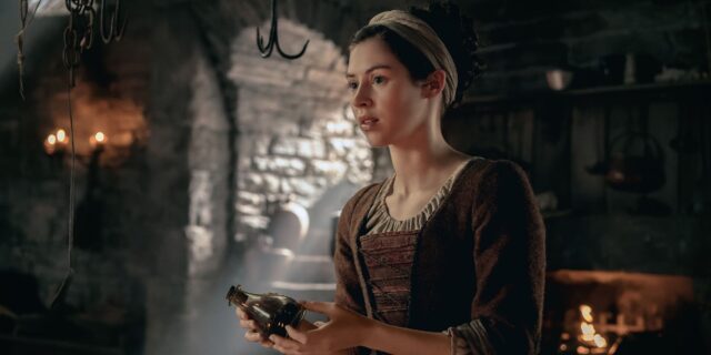 julia-holding-a-bottle-in-outlander-blood-of-my-blood.jpg
