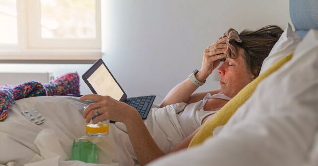 0_Woman-suffering-in-bed-with-a-fever-and-flu-like-symptoms.jpg