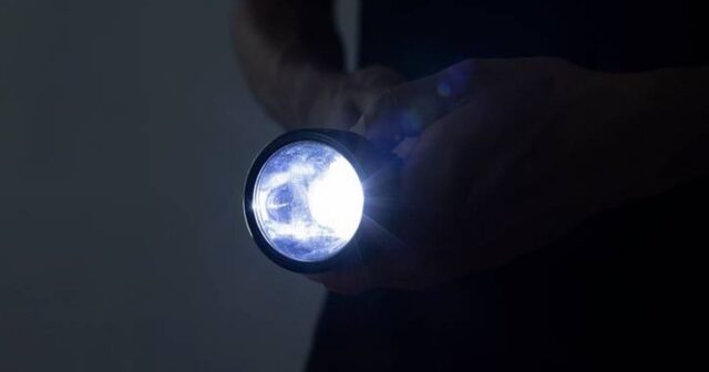 1_Unrecognizable-male-holding-a-flashlight.jpg