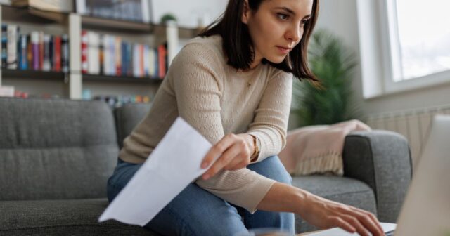 0_Woman-reviewing-financial-documents-while-working-on-her-laptop-at-home.jpg